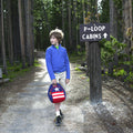 Young male hiker  carries the patriotic red and white and blue washable lunch-bag.   Lunchbag is made from a sustainable lightweight material.