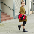 Back to school with girl wearing a red and black Scotty Dog Kid's Messenger Bag.