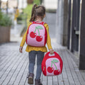 Girl carrying Dabbawalla machine washable red and pink Cherry Lunch bag and Backpack on her way home from school.