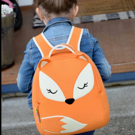 Girl wearing orange and cream environmentally friendly Dabbawalla Fox Backpack. 