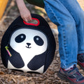 Child holding panda lunchbag.