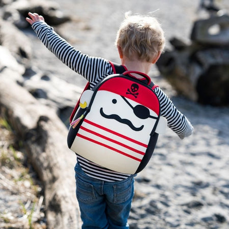 Young boy with the pirate design backpack from Dabbawalla Bags.