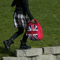 Girl at school carrying a red and blue lunch bag with a British flag design.
