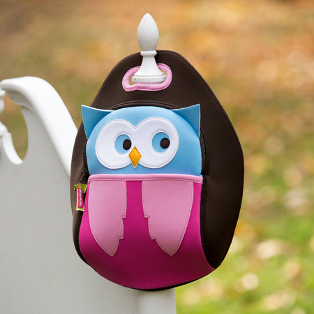 Hoot Owl Lunchbox is hanging on the post of a gate.