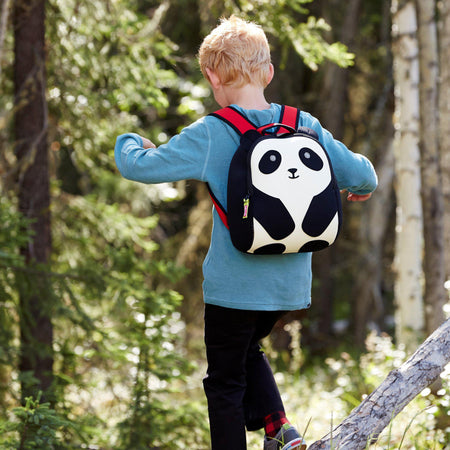 Young boy hiking in the woods with the Panda backpack.