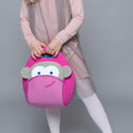 Young girl with pink dress holding the  cute Dabbawalla pink monkey lunchbox. 