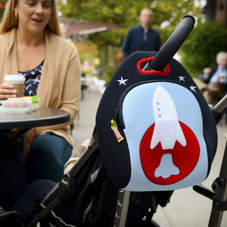 Space themed lunch bag makes a great stroller bag. Dabbawalla bags are washable and superior design. Graphic rocket design is appliqued on front of reusable lunch tote. Rocket ship is reaching for the embroidered stars.
