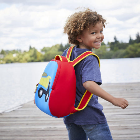 Preschool boy with a big smile wearing the Dabbawalla Bags truck theme backpack.